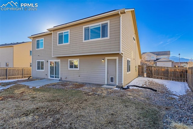 back of house featuring a yard and a patio area