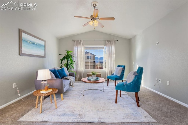 sitting room with ceiling fan, lofted ceiling, and carpet flooring