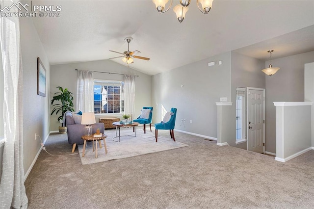 living area featuring lofted ceiling, ceiling fan with notable chandelier, and carpet