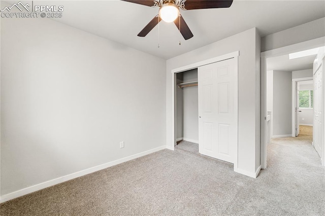 unfurnished bedroom featuring light colored carpet, a closet, and ceiling fan