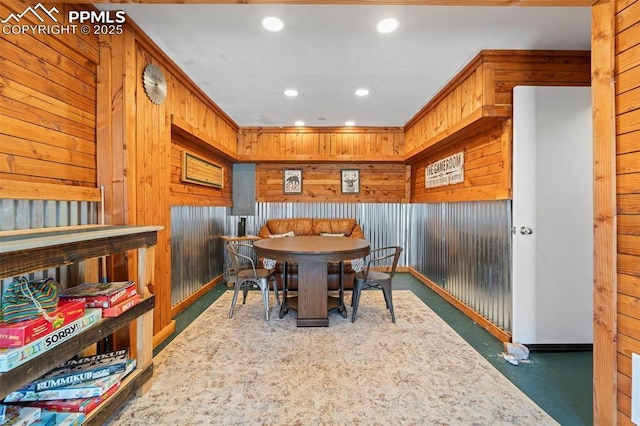 dining area with crown molding and wooden walls