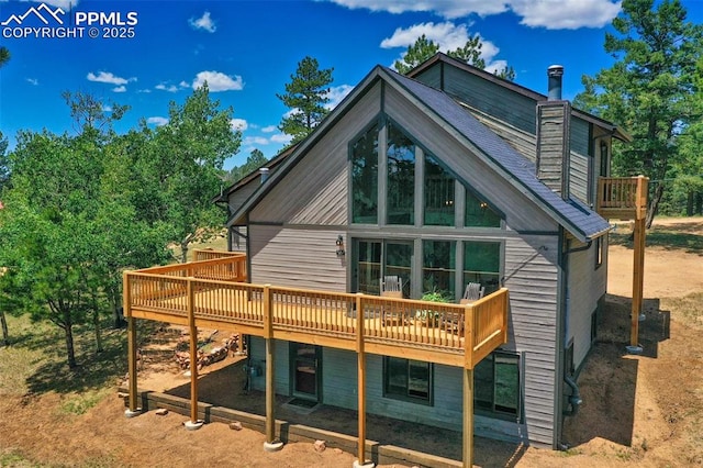 back of house with a wooden deck