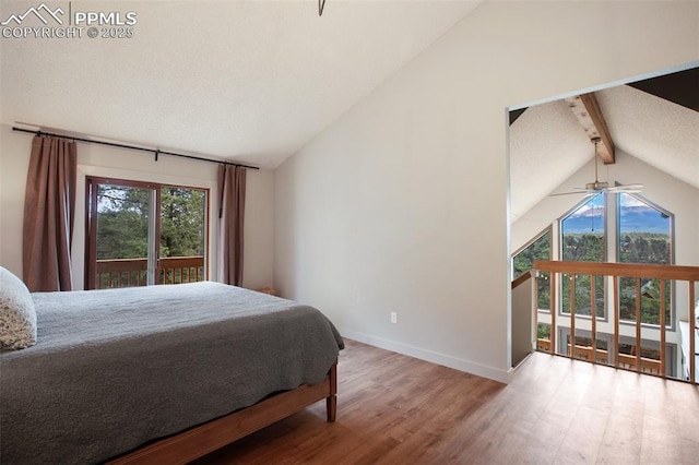 bedroom with lofted ceiling with beams and hardwood / wood-style floors