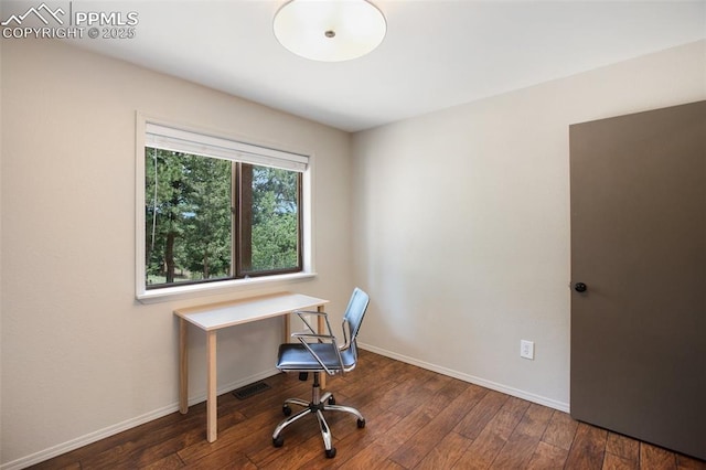 home office with dark hardwood / wood-style floors