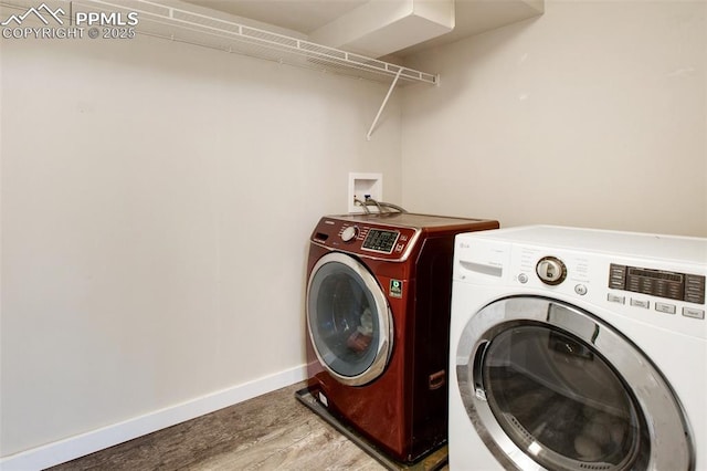 clothes washing area with washing machine and clothes dryer