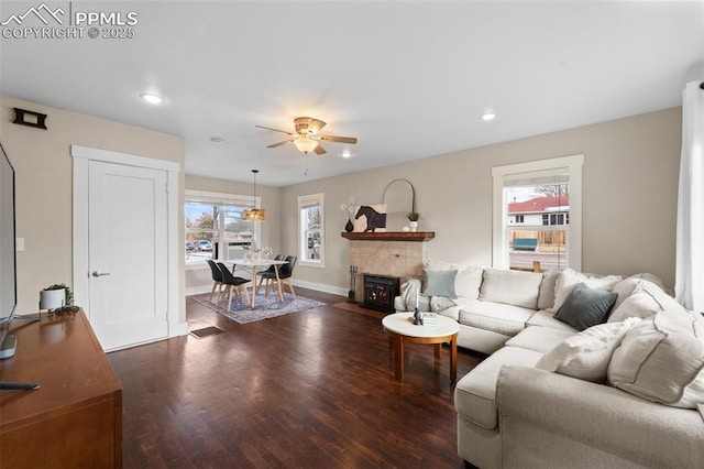 living room featuring dark hardwood / wood-style flooring and ceiling fan