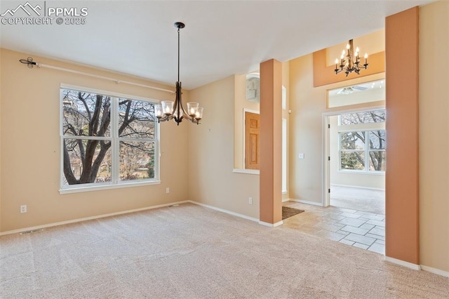 carpeted spare room with an inviting chandelier