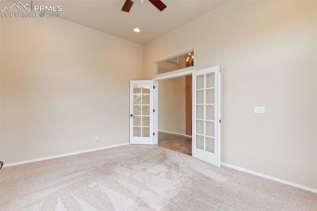 carpeted spare room with french doors and ceiling fan