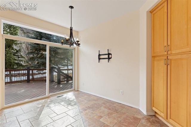 unfurnished dining area with a notable chandelier