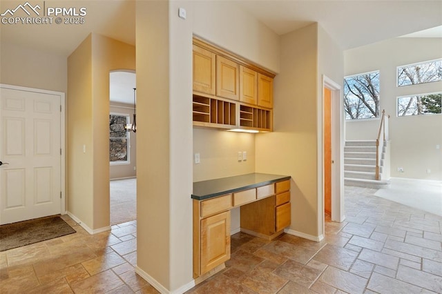 kitchen with built in desk and light brown cabinets