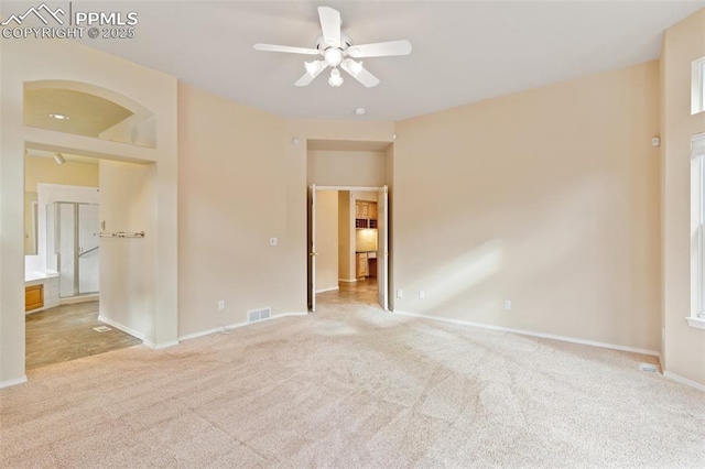 carpeted spare room with ceiling fan