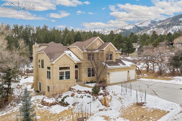 front of property featuring a garage and a mountain view