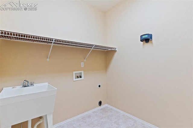 clothes washing area with light carpet, sink, hookup for a washing machine, and electric dryer hookup