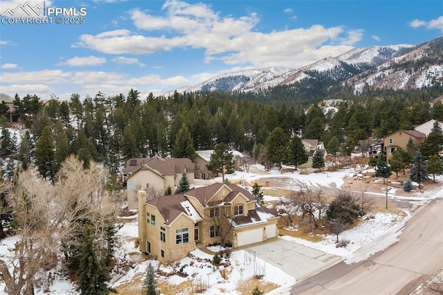 snowy aerial view with a mountain view