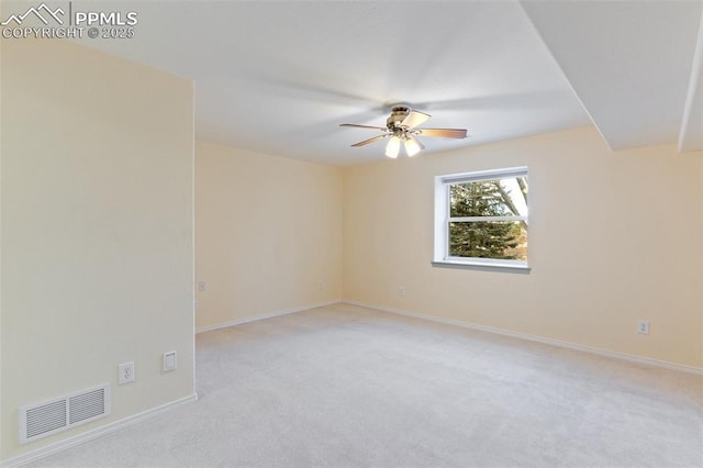 carpeted empty room featuring ceiling fan