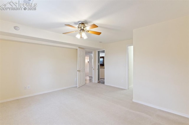 carpeted spare room with ceiling fan