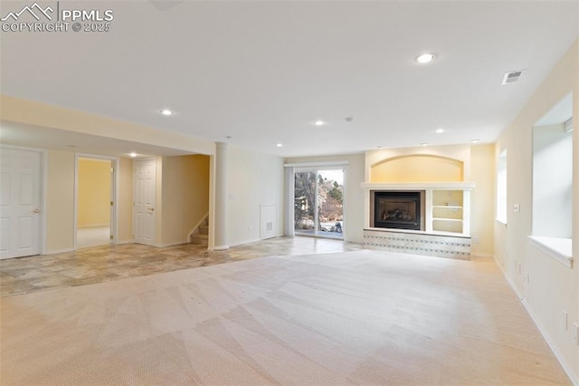 unfurnished living room with light carpet