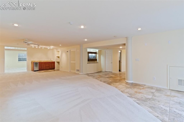 carpeted empty room with wine cooler and ceiling fan