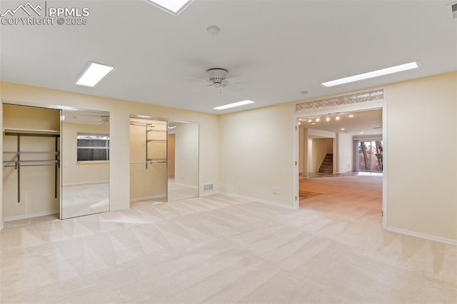 carpeted spare room featuring ceiling fan