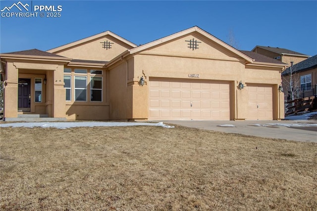 single story home with a garage and a front lawn