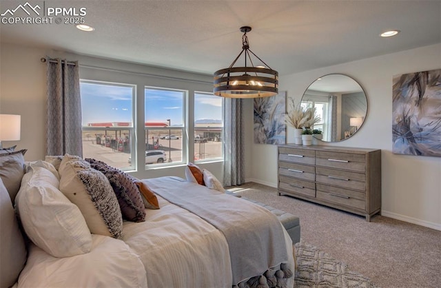 carpeted bedroom featuring a chandelier