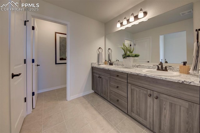 bathroom with vanity and tile patterned flooring