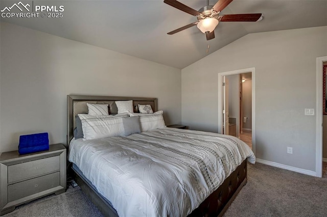 bedroom featuring vaulted ceiling, carpet flooring, ensuite bathroom, and ceiling fan