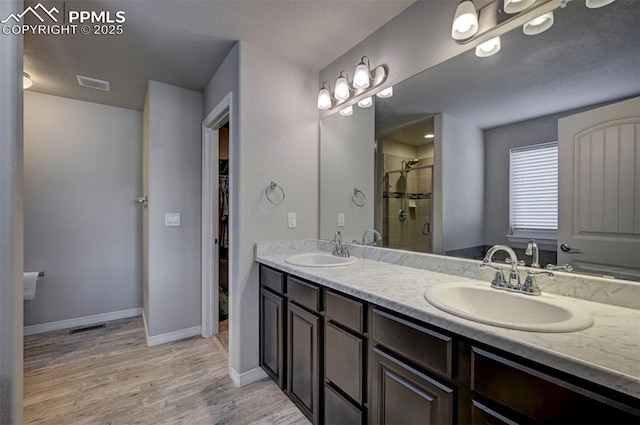 bathroom featuring vanity, an enclosed shower, and hardwood / wood-style floors