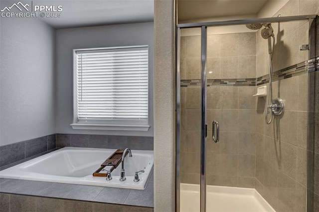 bathroom featuring separate shower and tub