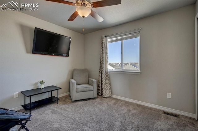 sitting room featuring light carpet and ceiling fan