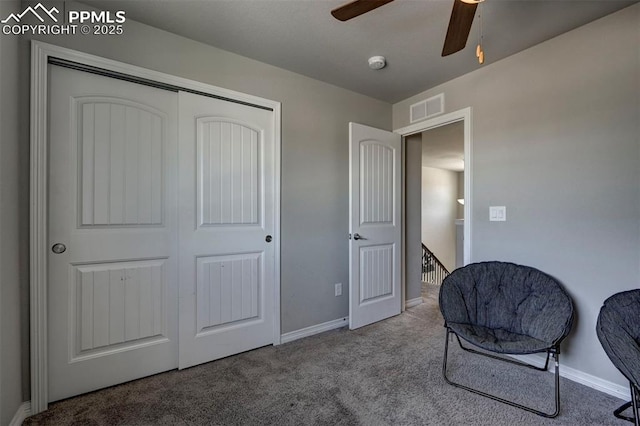 living area with ceiling fan and carpet floors