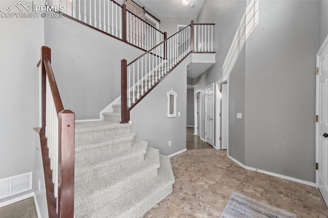 staircase with a high ceiling