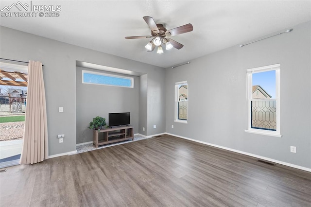 unfurnished living room featuring hardwood / wood-style floors and ceiling fan