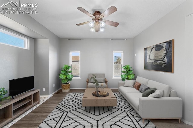 living room featuring hardwood / wood-style floors and ceiling fan