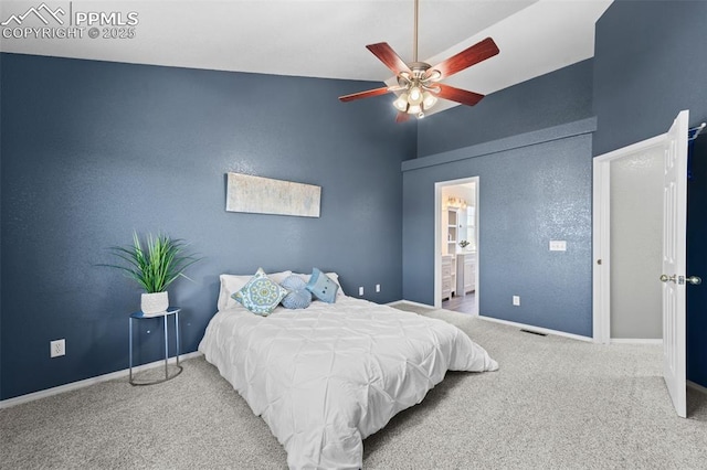 carpeted bedroom featuring high vaulted ceiling and ensuite bathroom