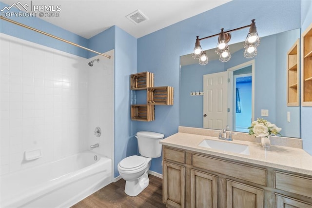 full bathroom featuring hardwood / wood-style flooring, vanity, bathtub / shower combination, and toilet