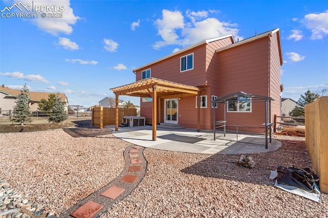 rear view of property with a pergola and a patio