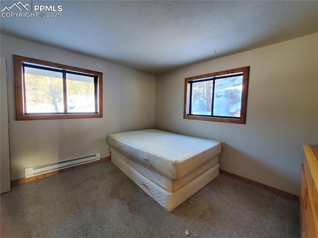 unfurnished bedroom featuring carpet floors and a baseboard radiator