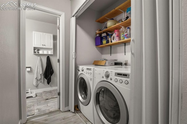 clothes washing area with washing machine and dryer and light wood-type flooring