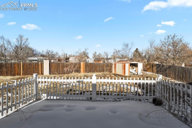 snow covered patio with a storage unit