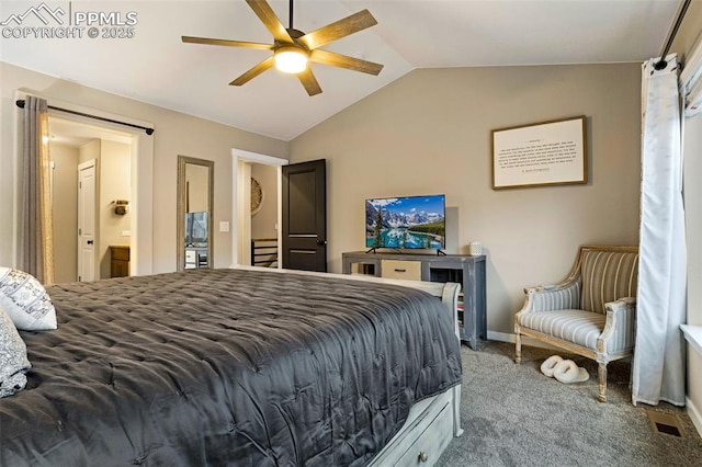 carpeted bedroom with connected bathroom, vaulted ceiling, and ceiling fan