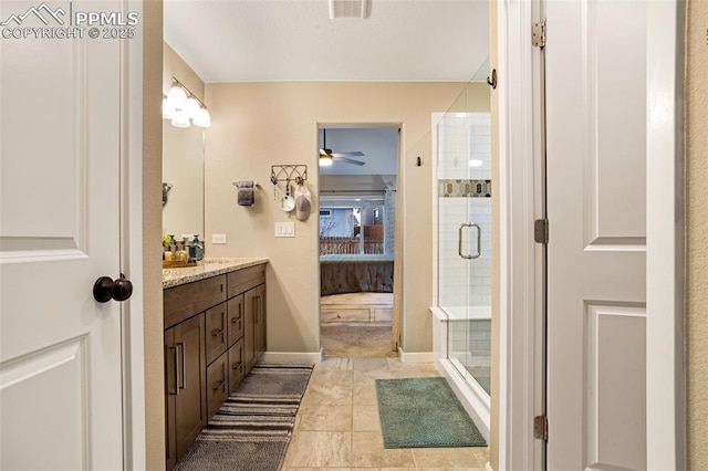 bathroom featuring vanity and an enclosed shower