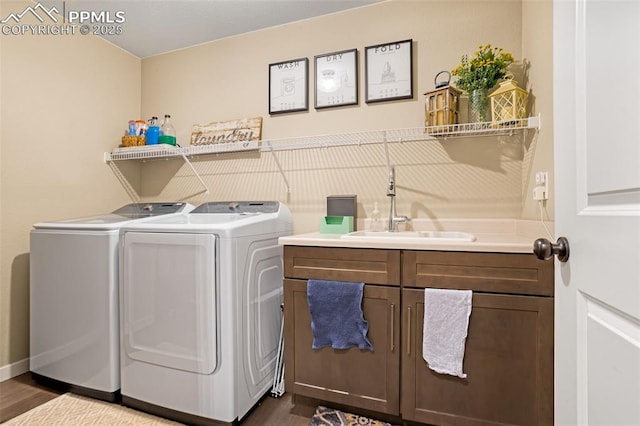 clothes washing area with cabinets, dark hardwood / wood-style floors, separate washer and dryer, and sink