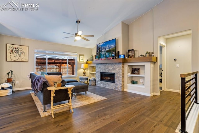 living room featuring dark hardwood / wood-style flooring, a fireplace, lofted ceiling, and ceiling fan