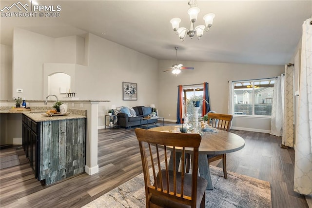 dining space featuring ceiling fan with notable chandelier, lofted ceiling, dark hardwood / wood-style floors, and sink