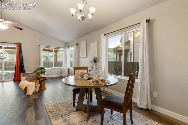 dining space with wood-type flooring, lofted ceiling, and ceiling fan with notable chandelier