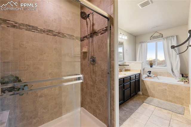 bathroom with tile patterned floors, vanity, and separate shower and tub