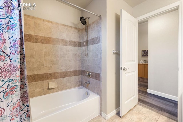 bathroom with tile patterned flooring and shower / bath combo with shower curtain