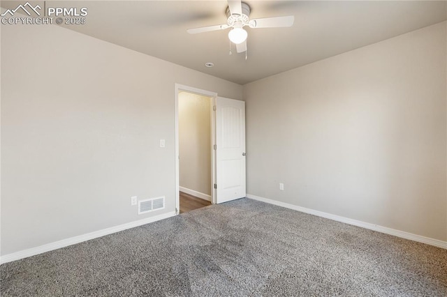 unfurnished room with ceiling fan and dark carpet