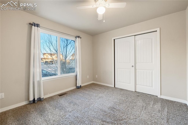 unfurnished bedroom featuring carpet flooring, ceiling fan, and a closet